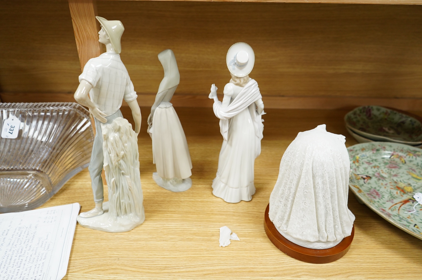 A group of Lladro figures: Bust of a lady in a lace veil, Girl with a basket, Lady holding gloves and a male reaper, 43cm high - 4 items, some boxed.